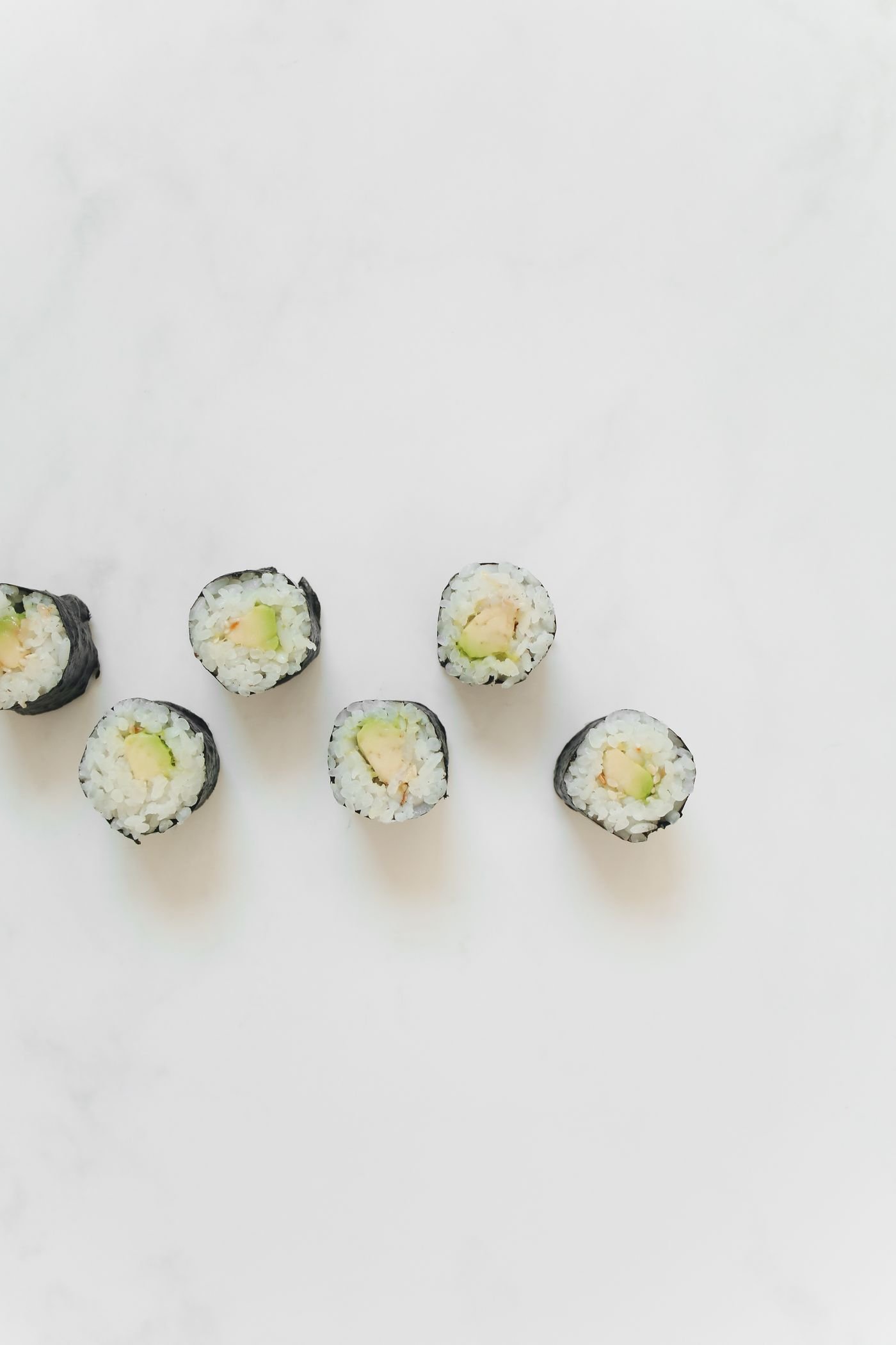 Sushi rolls arranged with precise negative space
